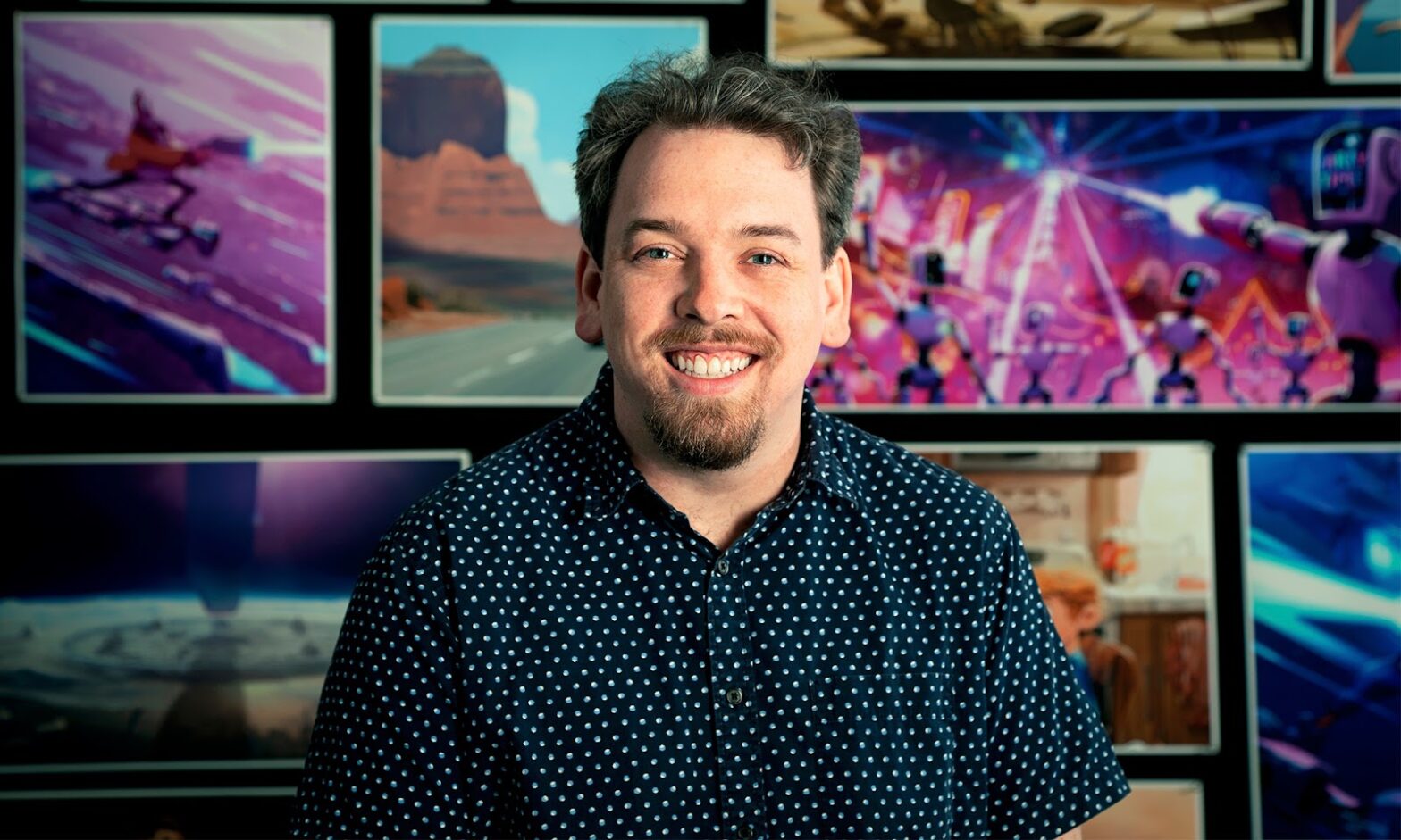 Michael Rianda in front of posters