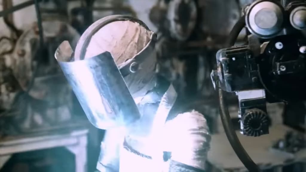 robot with a cylindrical head and illuminated eyes, lifting its visor in a mechanical workshop