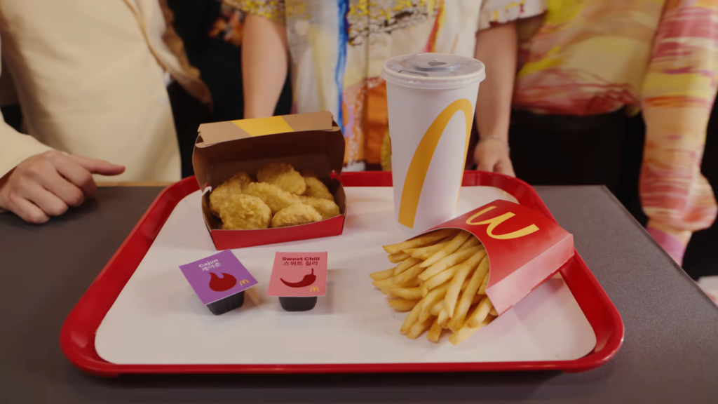A McDonald's meal on a tray with chicken nuggets, fries, a drink, and sauces